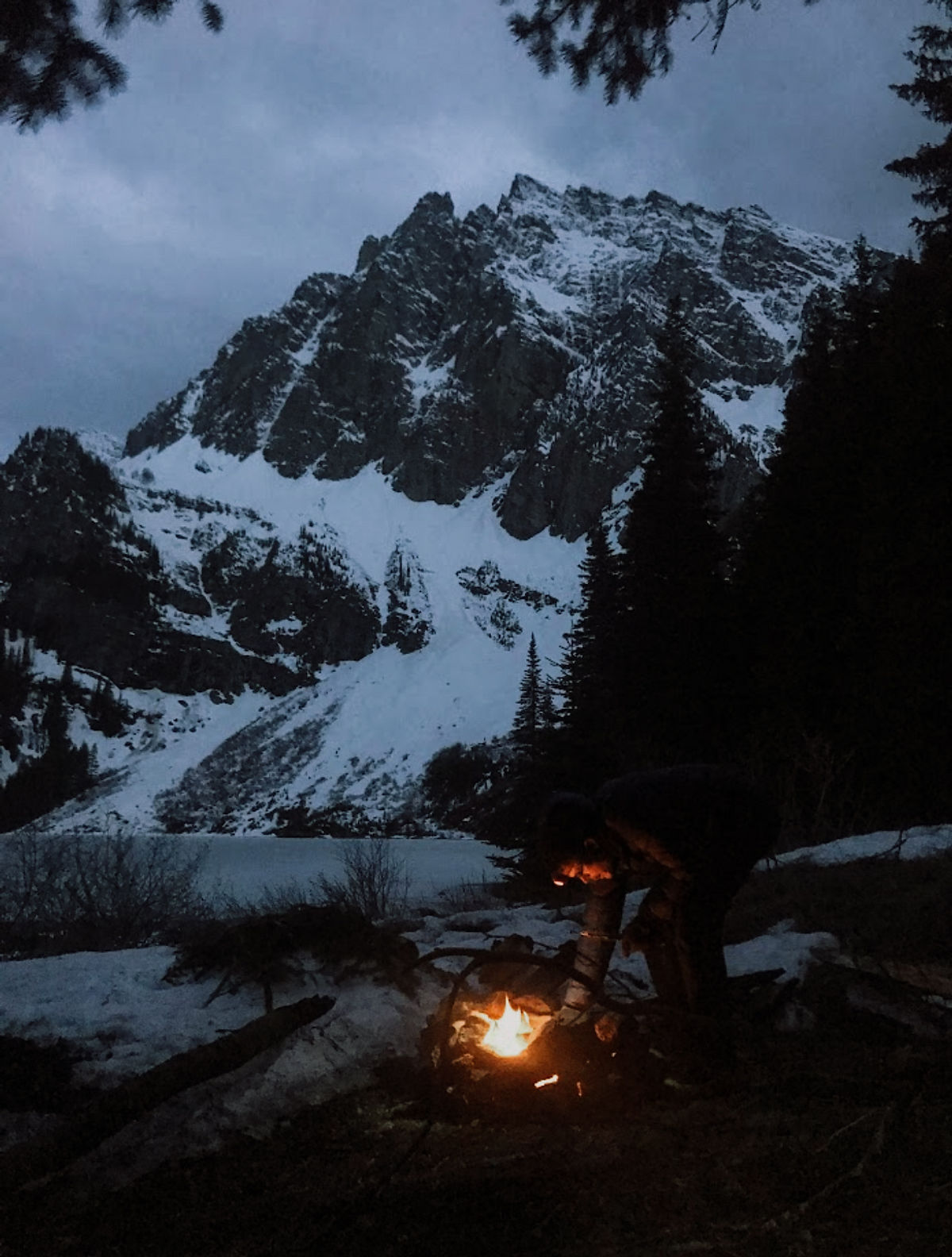 A campfire at the campsite before climbing Canmore Wedding Party with 'A Peak' in the background.